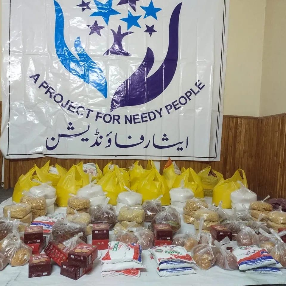 Ration packs lined up under our banner, ready for distribution