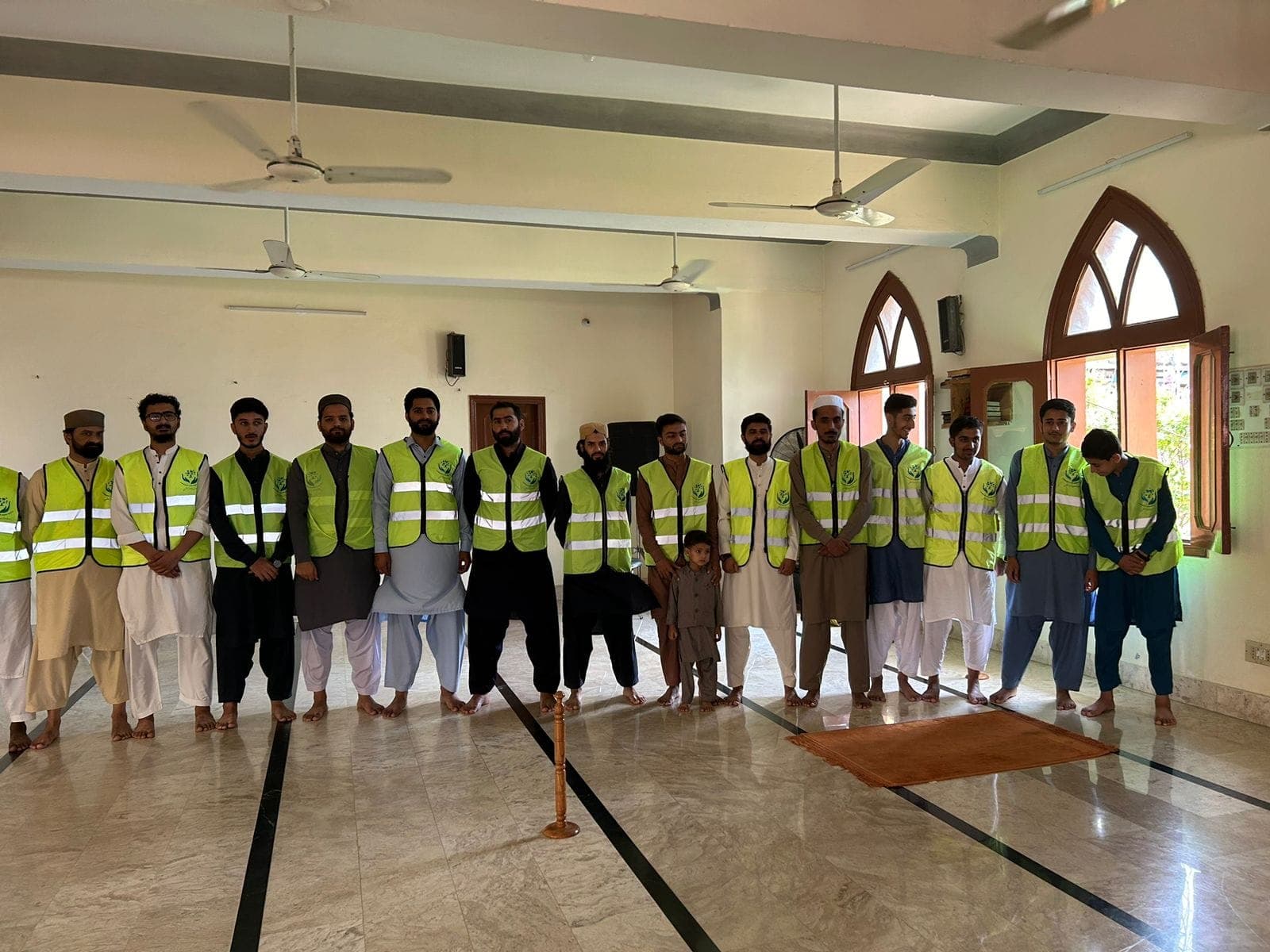 Karwan-e-Eesaar volunteers lined up in their vests before the 2024 eye camp