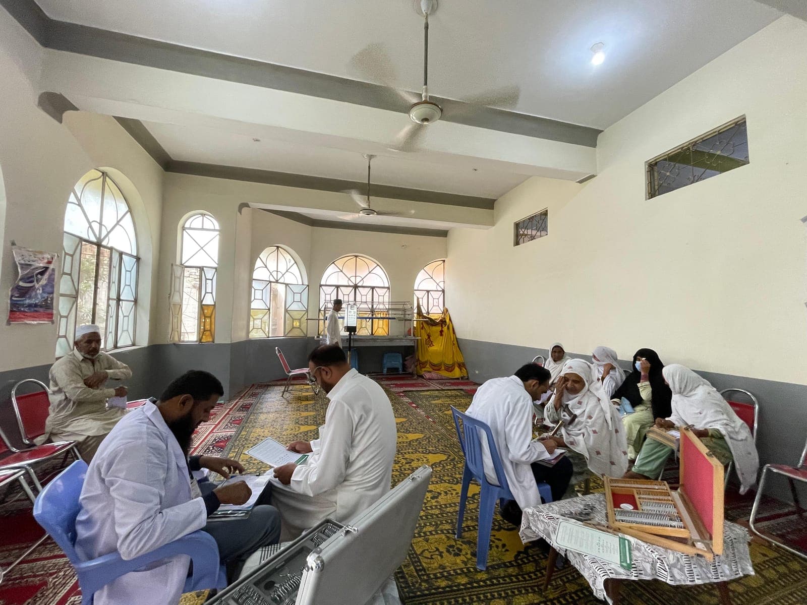 Doctors examining patients at the August 2024 free eye camp