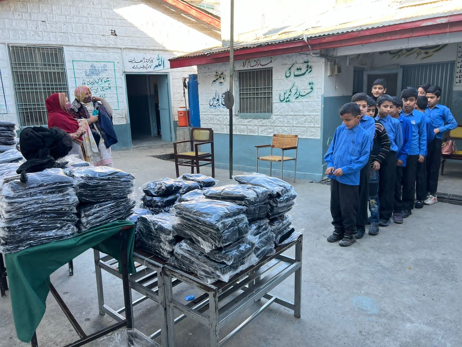 Schoolchildren queuing for their new sweaters, December 2023